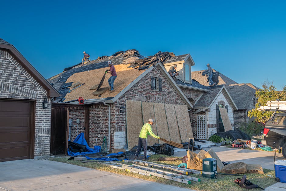 Workers engage in roof replacement on a brick house in Fort Worth, Texas.
